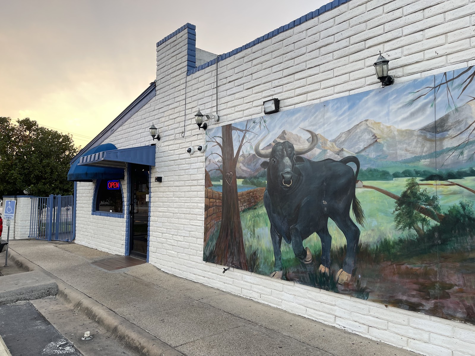 El Toro Mexican Food storefront with a hand-painted bull mural and lit OPEN sign